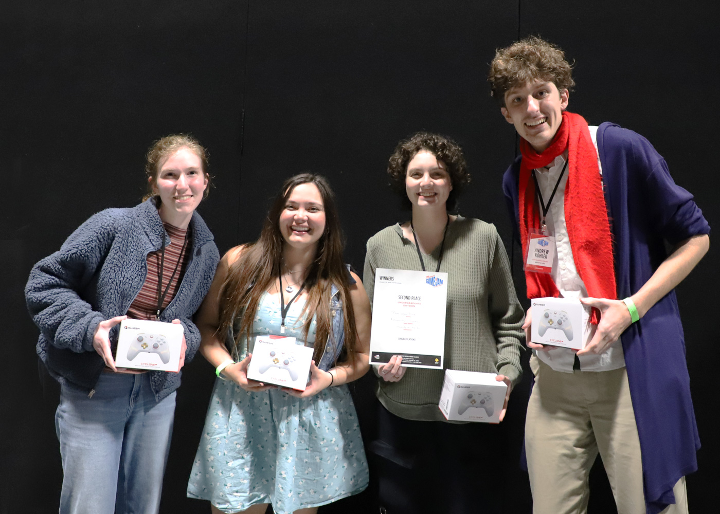 Group photo of four team members smiling