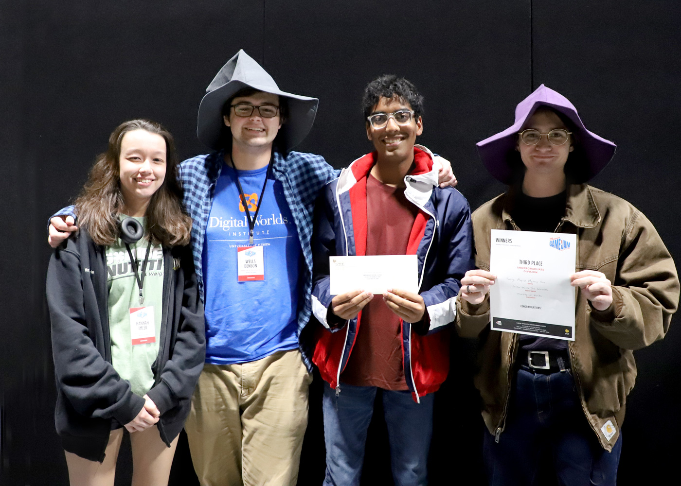 Group photo of four team members smiling