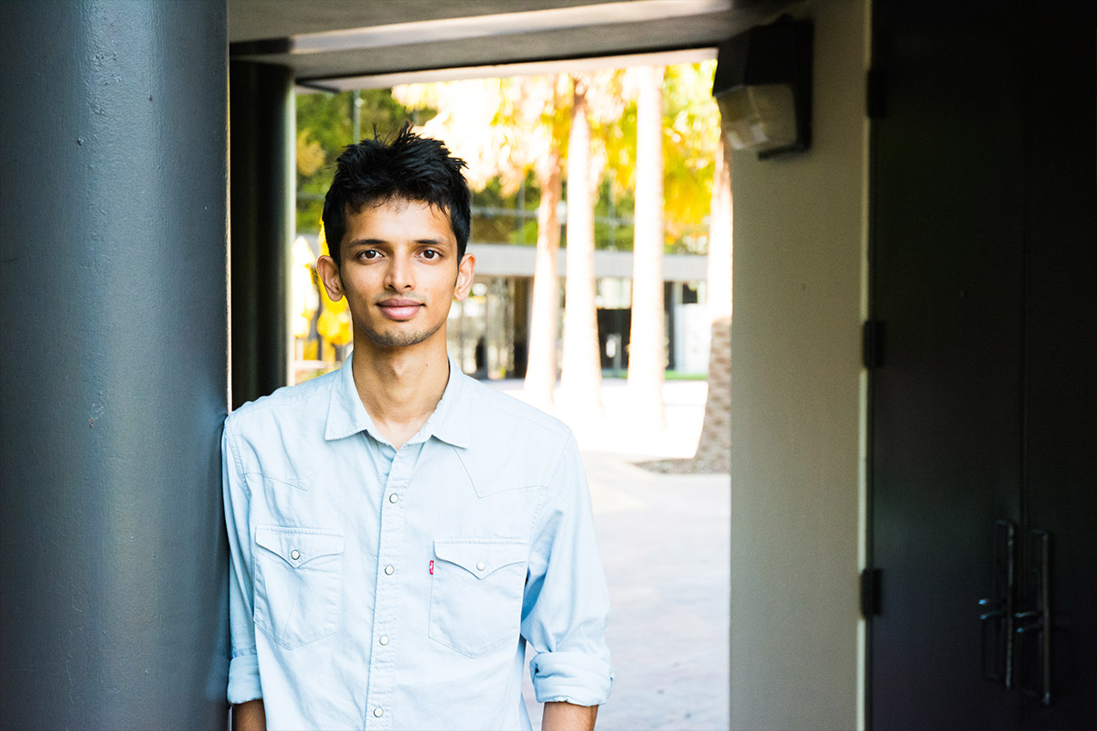 Male indian student standing outside of FIEA building