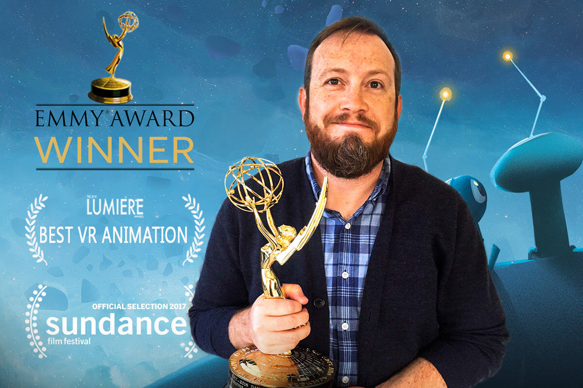 Male student holding Emmy award