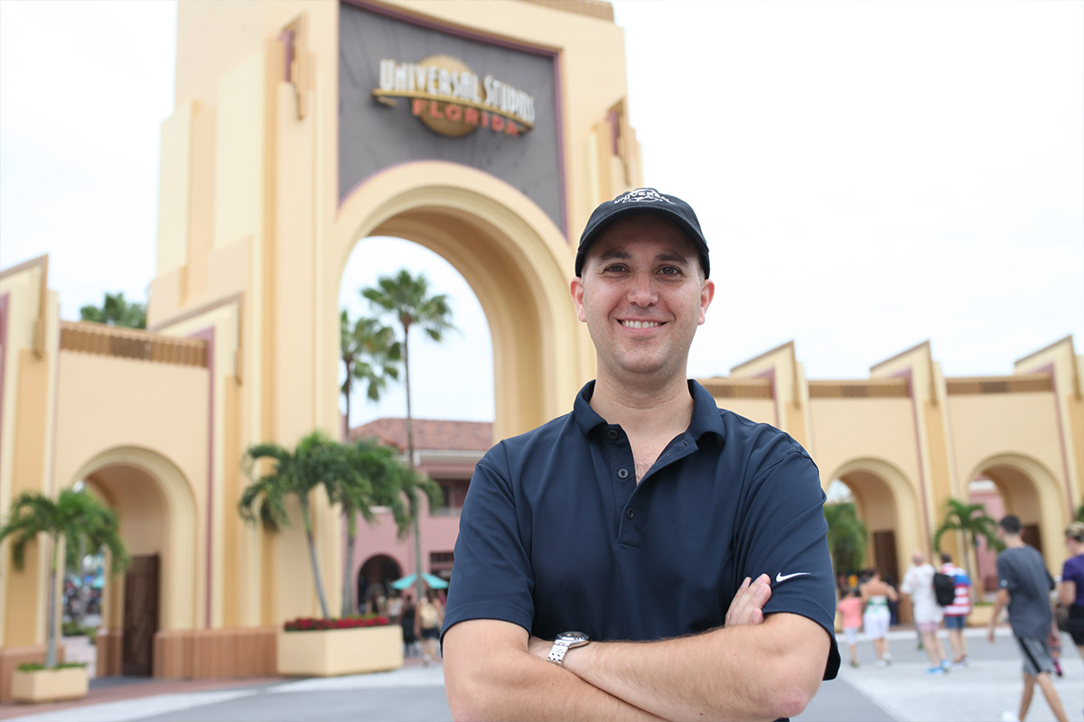 Male student standing outside of Universal Studios sign