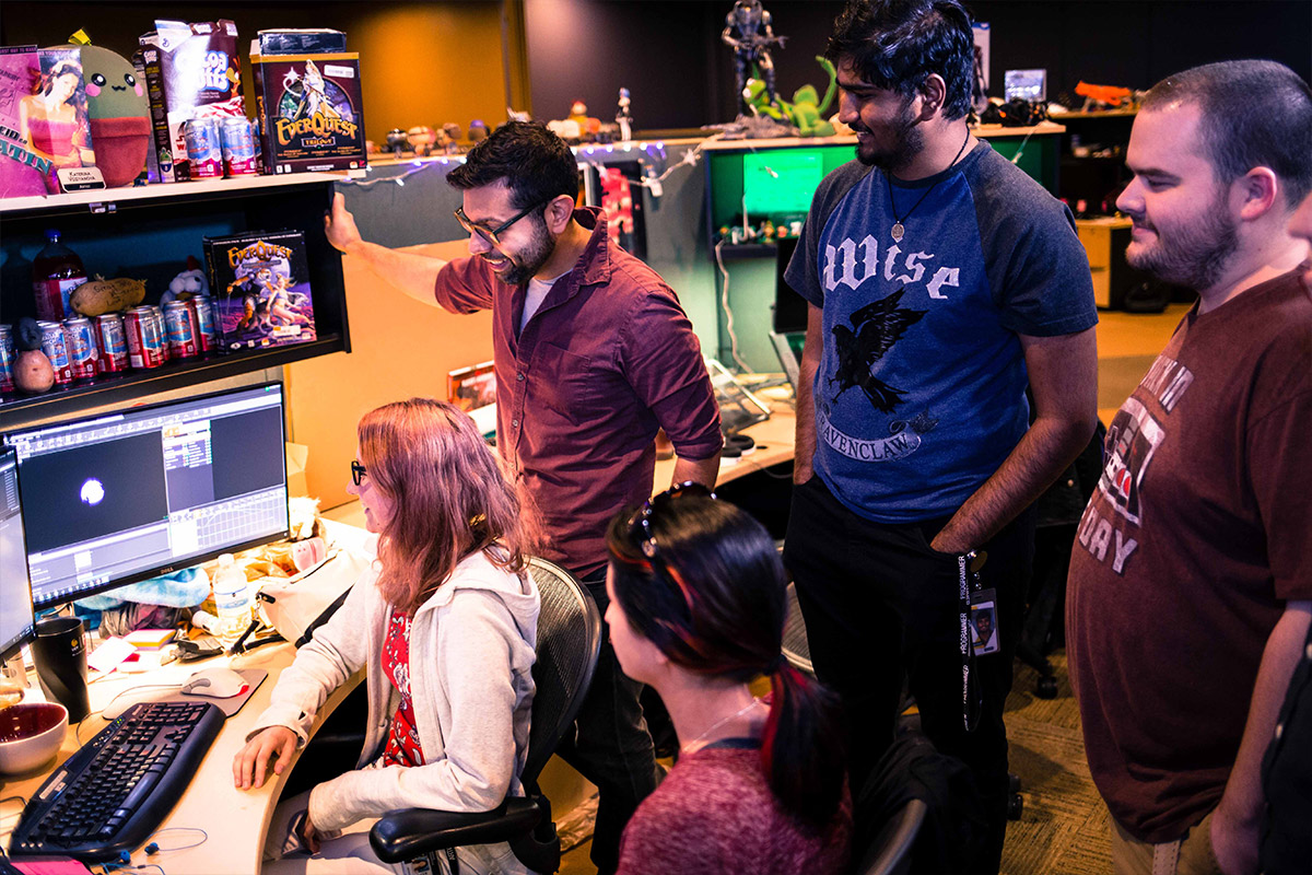 A group of students standing in their cubicle space