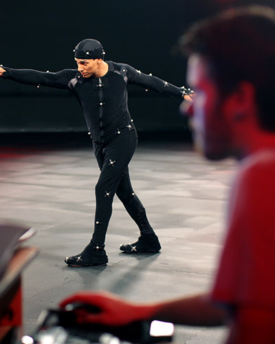 Young male wearing a motion capture suit in a pose