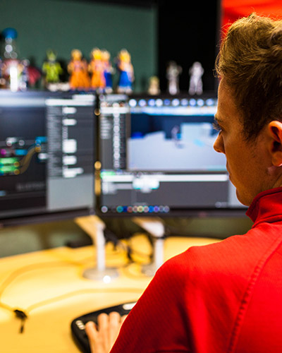 Young male sitting at his desk working on a project