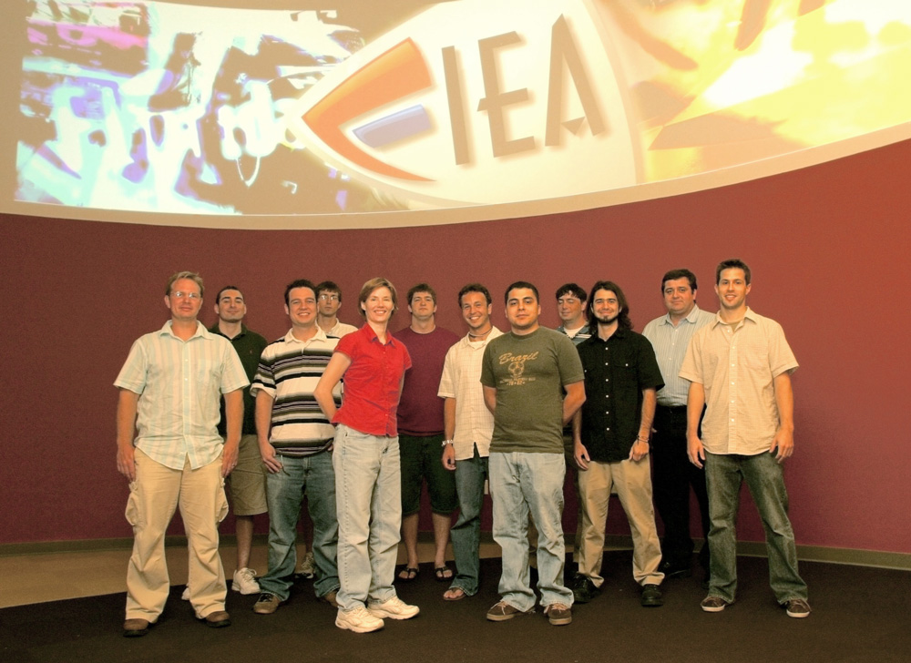 Group photo of Cohort 1 in front of the Nexus curved projected screen