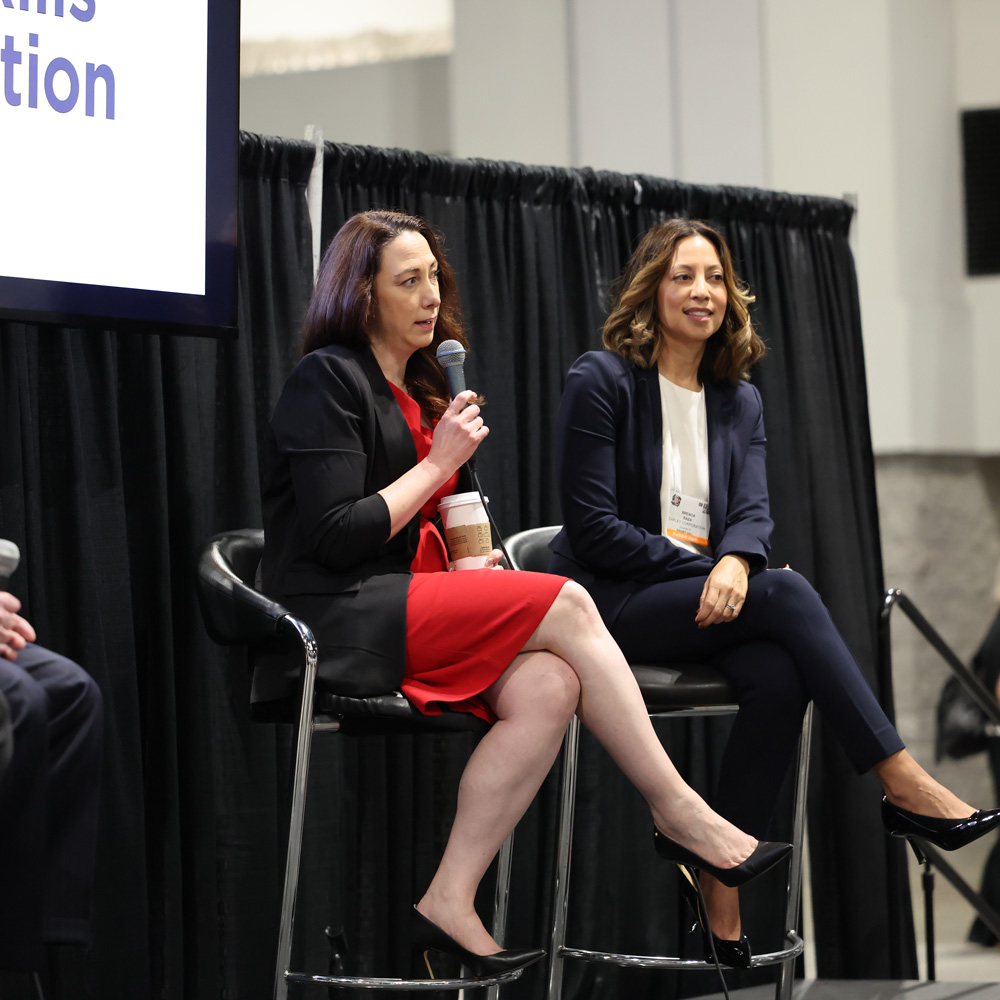 Jenn McNamara speaks to the audience and gives advice to FIEAns