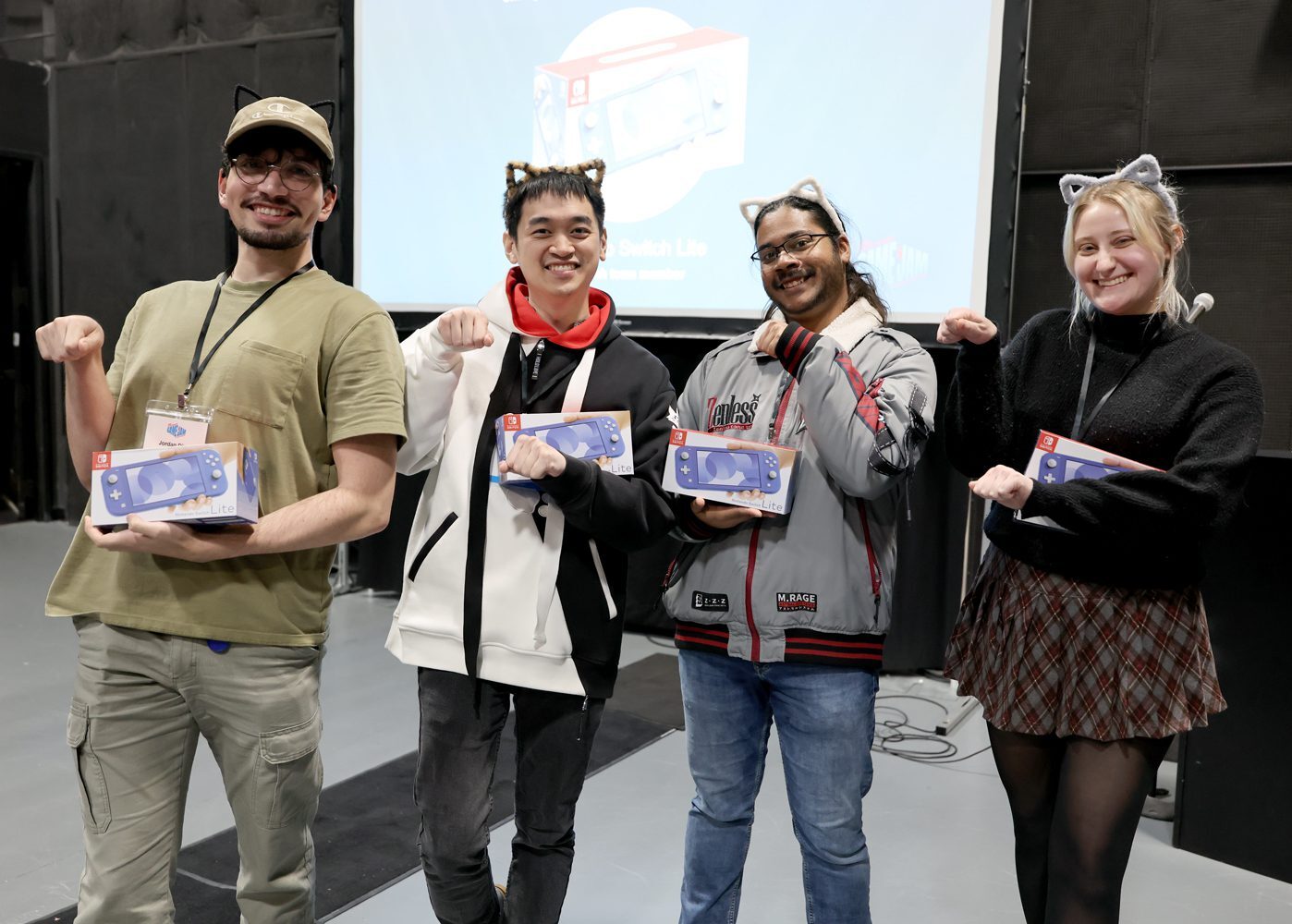 Group photo of four team members smiling