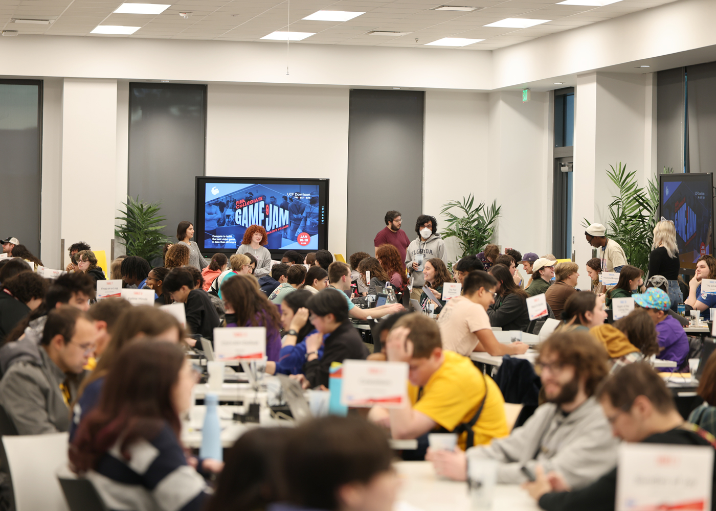Room full of Game Jam participants at UCF Downtown sitting in groups of four.
