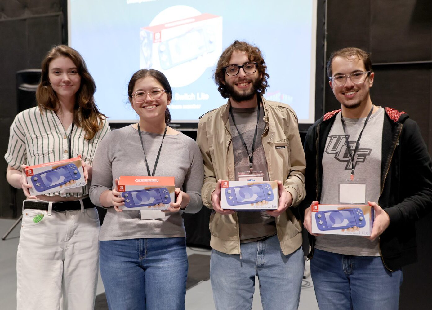 Group photo of four team members smiling