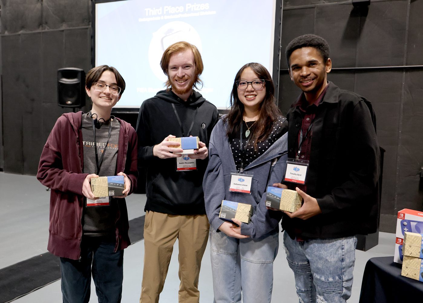 Group photo of four team members smiling