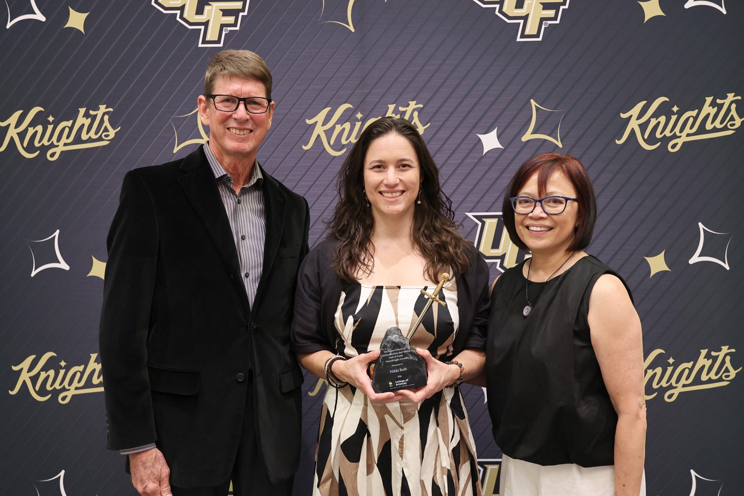 Nikki Roth surrounded by her parents shortly after accepting her NSCM Hall of Fame award